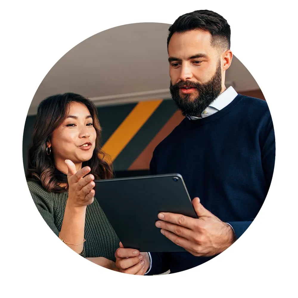Woman and man looking at a tablet while having a discussion
